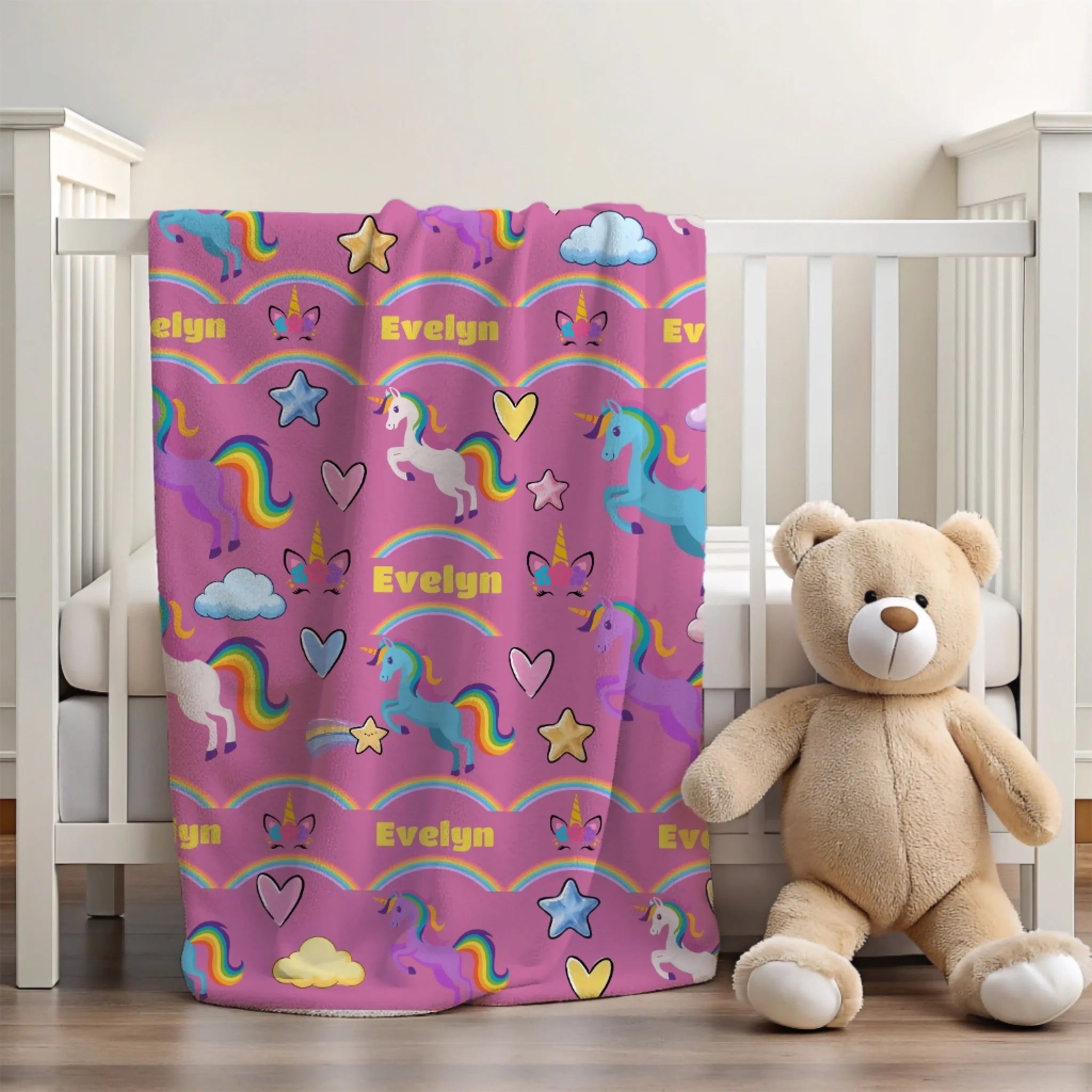 Rainbow unicorn personalized blanket in crib light pink